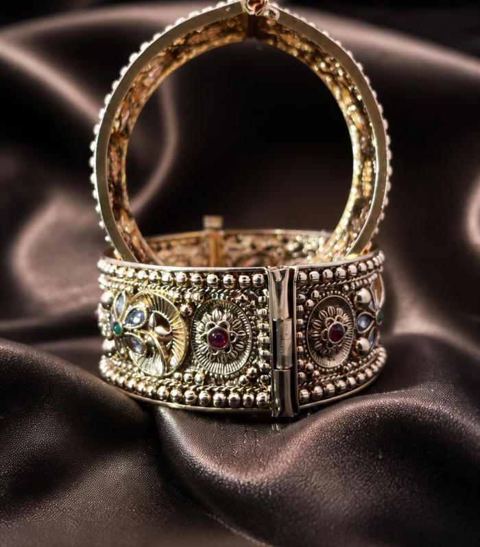 Wide gold-tone cuff bangle with ruby emerald and polki stones by Samaya Jewellery